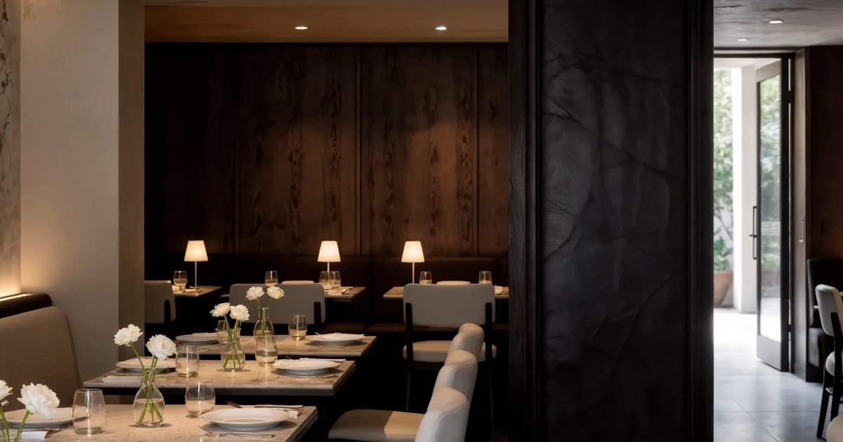 A restaurant table set for first service in warm light
